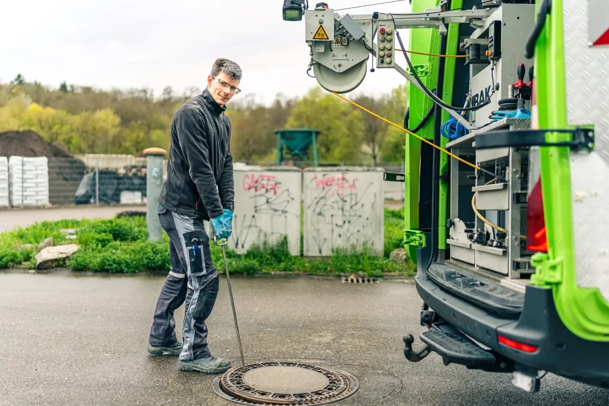 Techniker reinigt Pumpensumpf im Keller